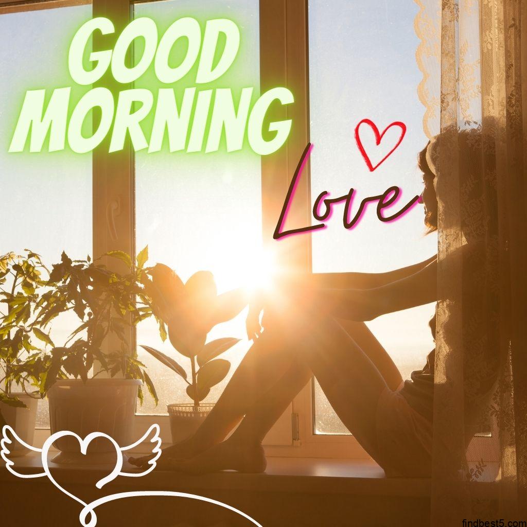Good Morning love image with a girl sitting on window looking at the sun outside window